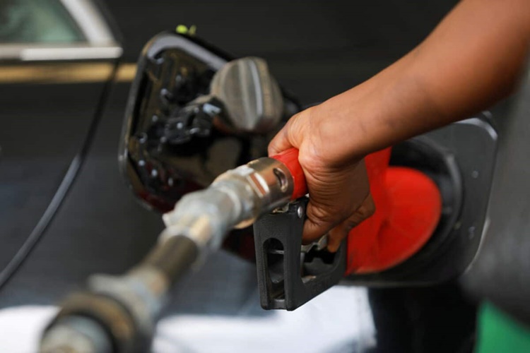 File photo: a gas station attendant pumps fuel into a customer's car at the nnpc mega petrol station in abuja