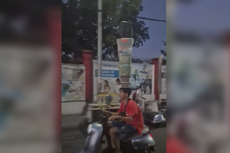 Motorcycle rider turns heads with balancing act of plastic boxes